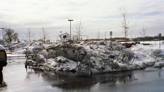 [Somewhere in CO] The pile of frozen shopping carts in the Wal-Mart parking lot was really a fitting symbol for our marooning experience in the wastleand that was downtown Denver in the middle of a blizzard.