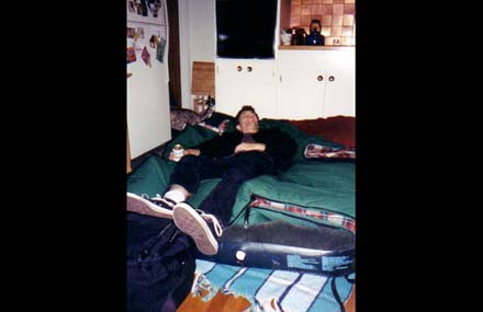 [Seattle, WA] Jon pretends to pass out with a Hamm's at Rob's house. The Jones-Gunn family let us sleep in their kitchen, for which we are grateful. 